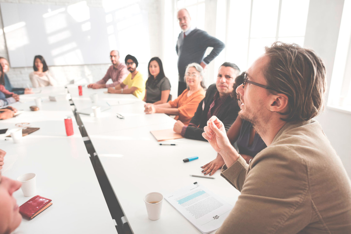 Colleagues talking at a table