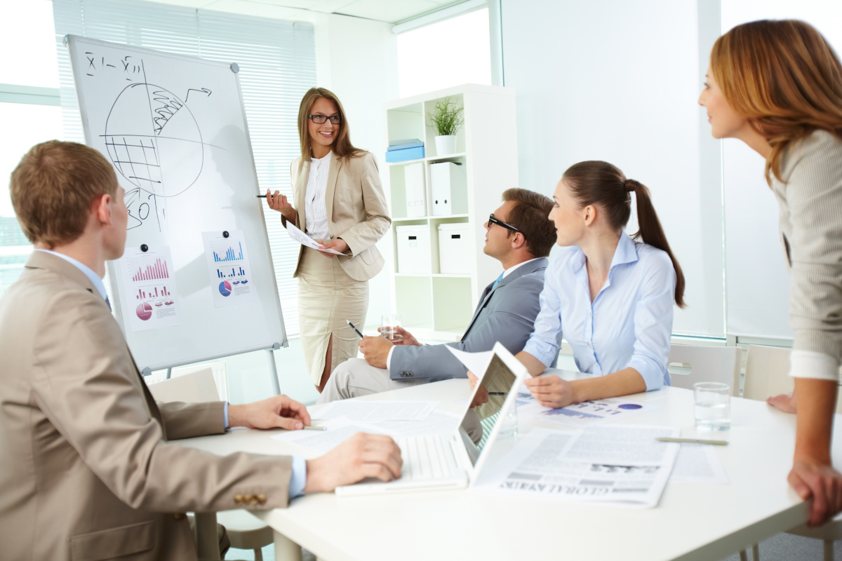 A businesswoman giving a presentation to her colleagues