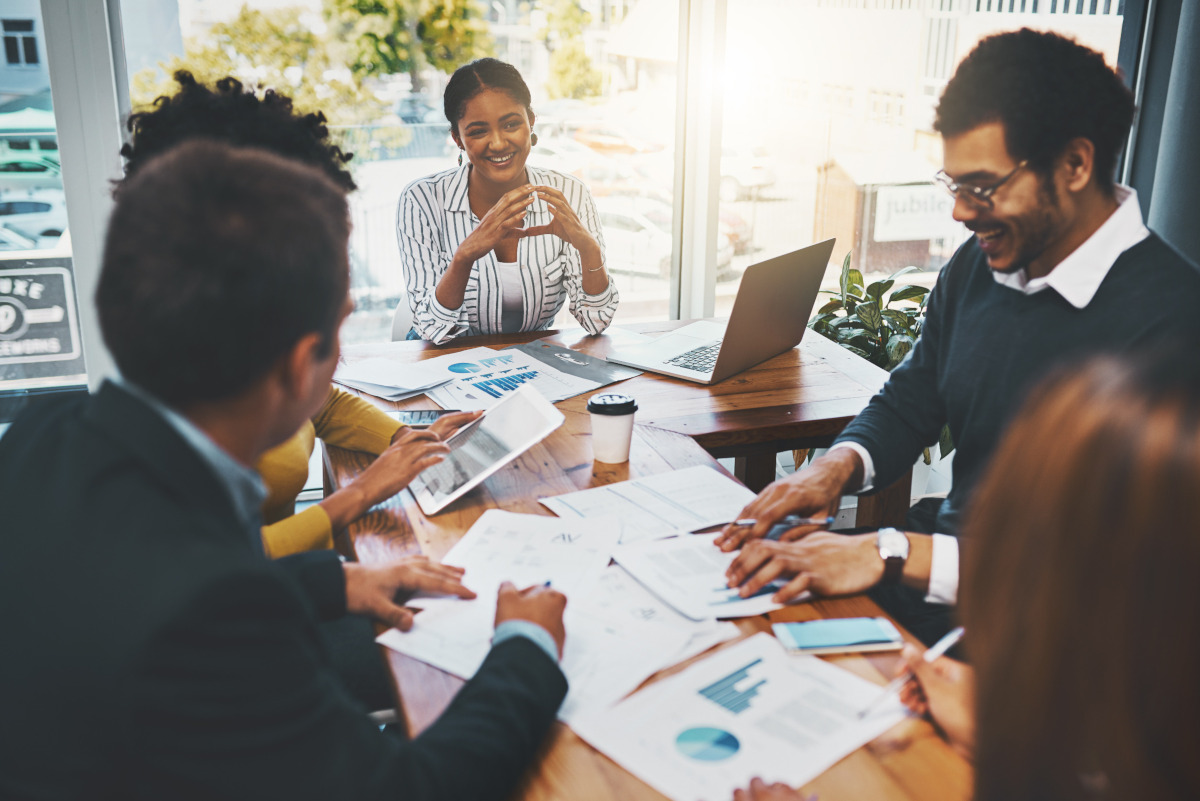 Colleagues sitting at a table discussing business plans