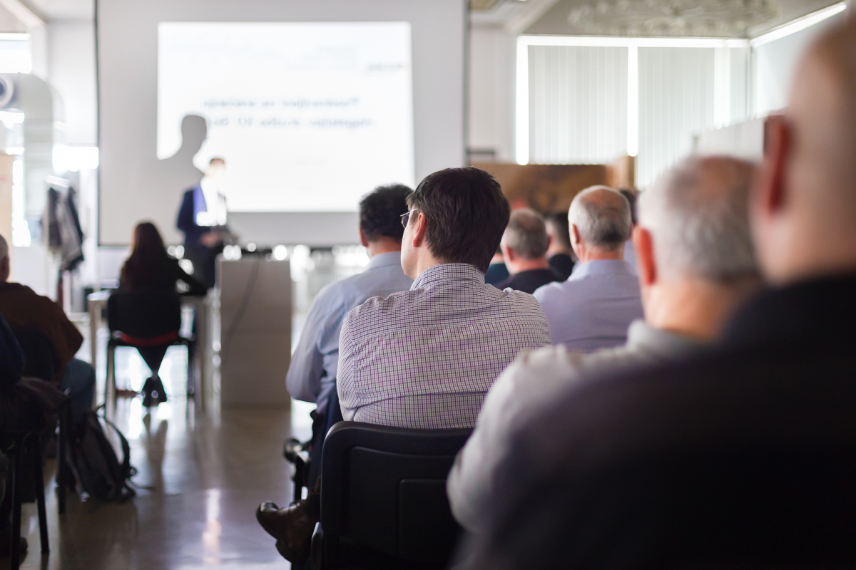 A group of people watching a presentation